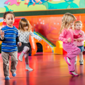 Kids playing inside on a mat
