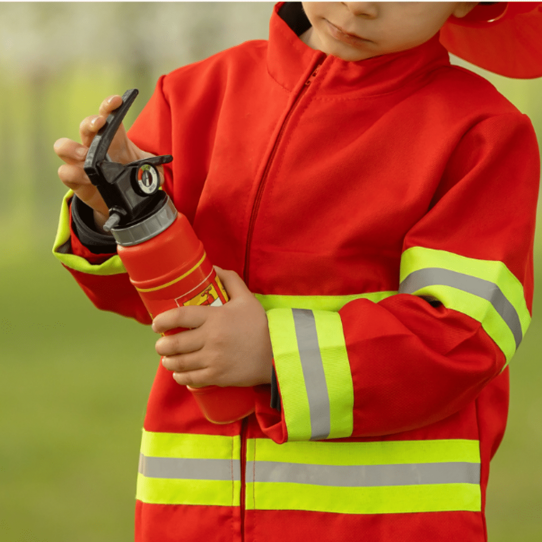 Kid playing with toy fire fighter items