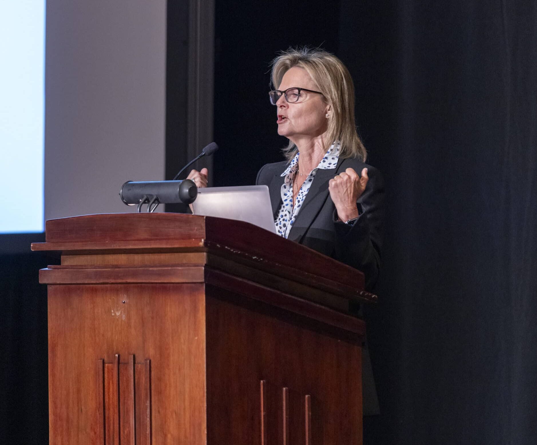 Photo of Nadin Benrey speaking at the podium 